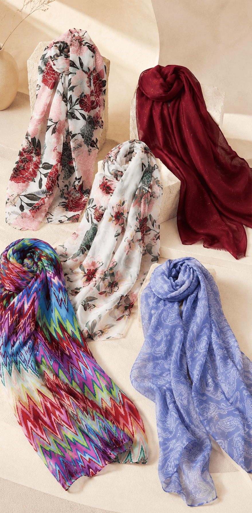 Long floral printed scarf with gold accents draped on mannequin