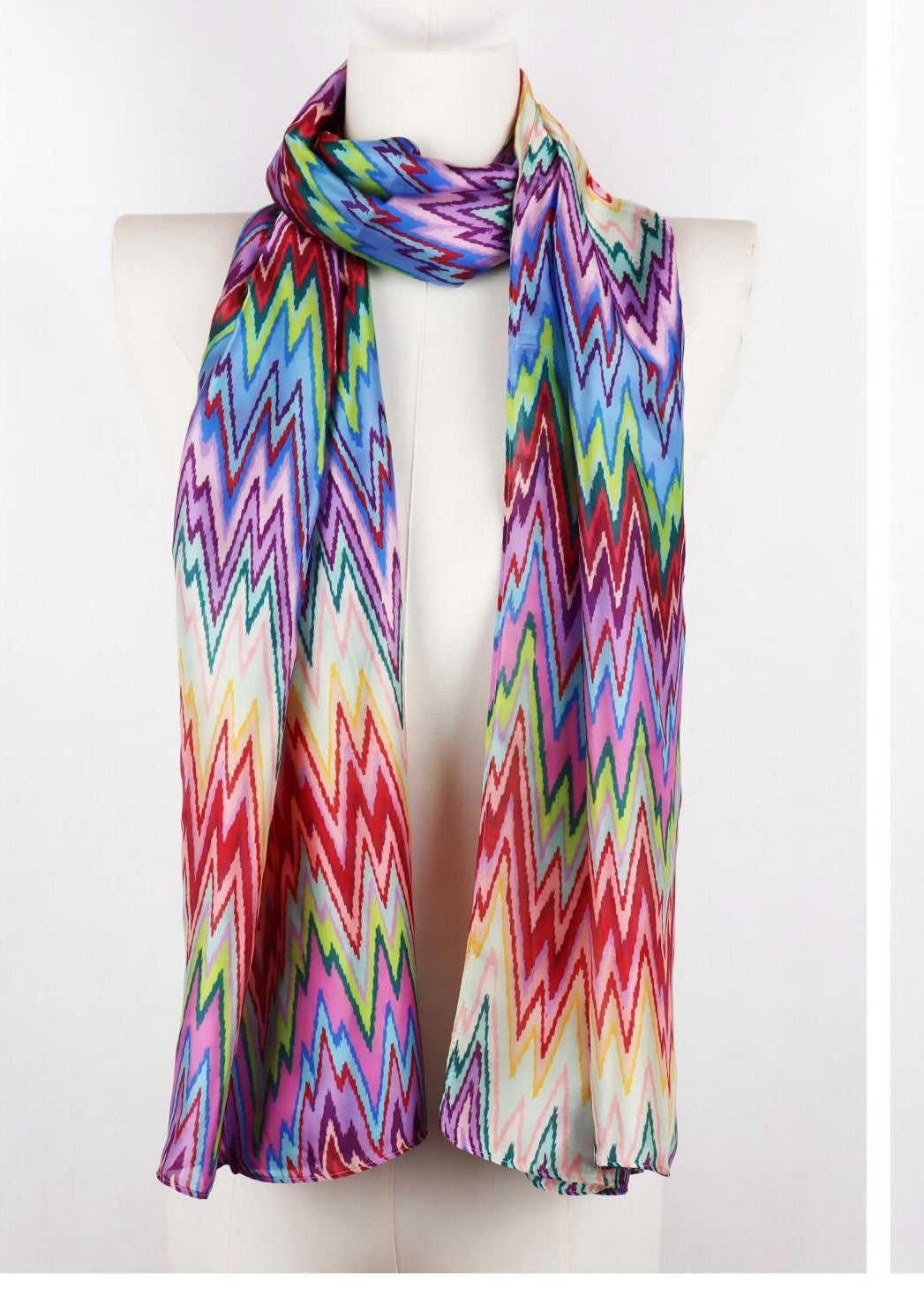 Long multicolor chevron zigzag scarf draped on mannequin