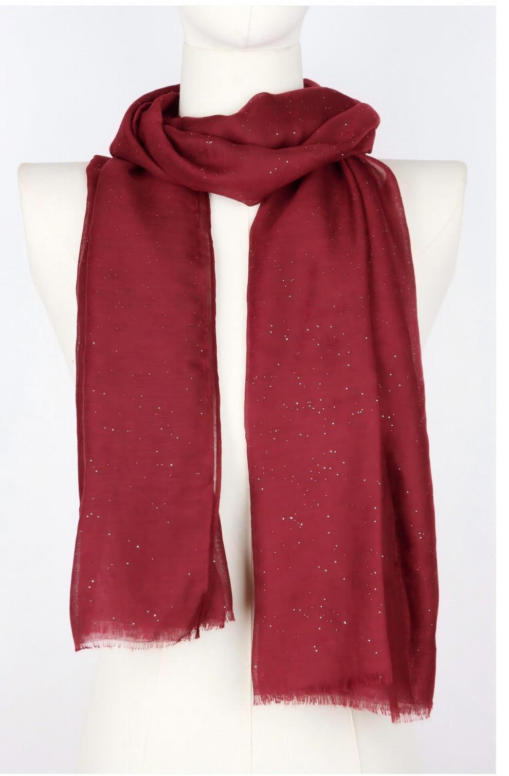Long burgundy scarf with silver glitter dots draped on mannequin