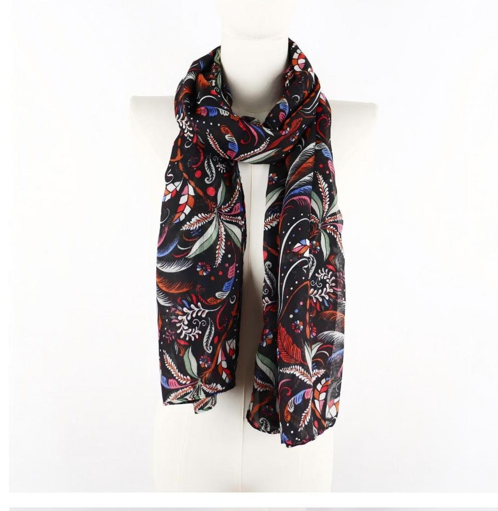 Black feather and botanical decorative long scarf on mannequin